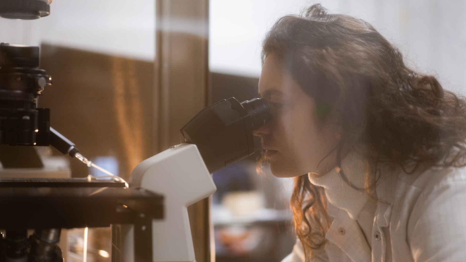 researcher at the microscope